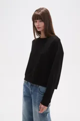 Buzo de manga larga color malva/rosado pálido, de corte holgado y cuello redondo.