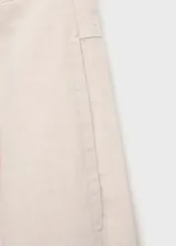 Pantalón de lino color beige, de tiro medio, corte recto y diseño largo.
