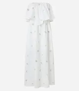 Vestido midi evasé sin mangas, confeccionado en tricolina color blanco, con escote recto con volantes y bordados metalizados de iconos.