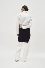 Camisa blanca de popelina de algodón, con cuello solapa y mangas largas con puños abotonados.