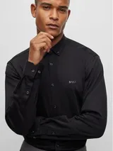 Camisa negra de manga larga con cuello abotonado y logo bordado en el pecho. Corte regular fit.