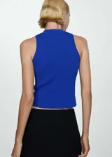 Top azul con panel blanco horizontal, cuello perkins y cierre de cremallera en el cuello.