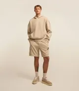 Bermuda masculina color beige confeccionada en tela french terry, con cintura elástica, cordón interior para ajustes y bolsillos cargo.