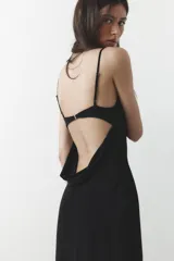Vestido largo negro de escote fluido y tirantes finos ajustables.