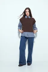 Chaleco tejido sin mangas de color negro, con cuello redondo y diseño de textura sutil. Presenta un corte recto con terminaciones acanaladas en el ruedo y hombros levemente estructurados.