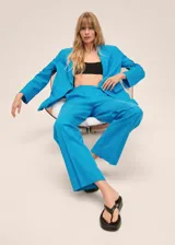 Pantalón de vestir celeste de corte recto, con bolsillos laterales y traseros.