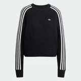Buzo de crochet negro con calce amplio, cuello redondo acanalado y las icónicas tres franjas blancas de Adidas en las mangas. Presenta el logo del trébol de Adidas bordado en el pecho.