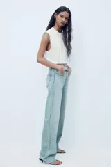 Pantalón de jean azul de corte wide leg, tiro alto y largo hasta el tobillo.