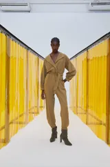 Mono largo color marrón claro, con cuello camisero, mangas largas abullonadas y cinturón de tela.