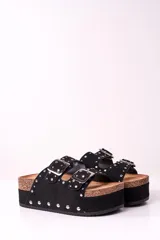 Sandalia de plataforma color negro con dos tiras gruesas con hebillas plateadas y apliques de tachas plateadas.