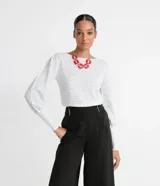 Blusa de manga larga abullonada, con cuello redondo y tejido de punto texturizado.