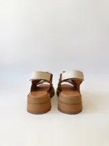 Sandalias de cuero color marrón con plataforma y dos tiras anchas de cuero crudo con velcro.