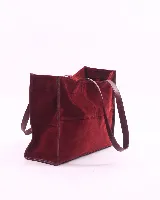 Bolso tipo shopper de cuero color bordó, con doble asa de hombro y cierre magnético. Incluye un amplio bolsillo interior con cierre de cremallera.