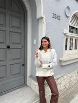 Sweater gris con estampado de flores blancas, cuello en V y mangas largas.