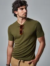 Remera de punto tejida color verde militar, con cuello redondo y mangas cortas.