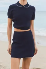 Minifalda azul marino de punto con cintura elástica y ribete de contraste en el bajo.