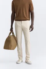 Pantalón chino azul marino, corte skinny fit, confeccionado en tejido de algodón con elasticidad. Cuenta con bolsillos frontales y traseros de vivo. Cierre frontal con cremallera y botón.