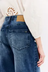 Pantalón de jean azul de tiro alto, corte palazzo y pierna ancha.