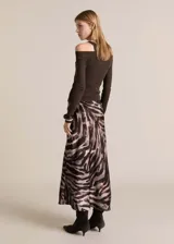 Falda midi de satén con estampado animal print de cebra en tonos marrones y beige.