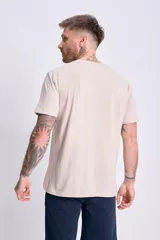 Remera de manga corta color beige con estampado vertical "Human Nature" en el frente.