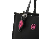 Cartera mediana tipo shopper color marrón, con doble asa de hombro y cierre superior. Incluye un dije colgante con forma de labios y logo de la marca en color fucsia.