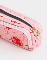 Cartuchera rosa claro con estampado de moños rojos y logo de cerezas. Tiene tres divisiones internas con cierre y tiracierre de moñitos.