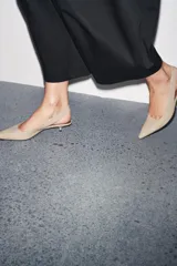 Zapato destalonado color beige con tira trasera elástica ajustable, punta fina y tacón kitten.