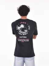 Remera negra de corte oversized con estampado circular en el pecho que incluye una palmera, una ola y la palabra 'Paradise'.