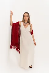 Ruana tejida de hilo color rojo con lurex y terminación de flecos.