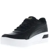 Championes urbanos Puma Skye Wedge Wns, color negro con detalles dorados y suela blanca.