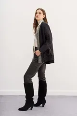 Saco negro acolchado con diseño de ondas y ribete bordado con cuentas.