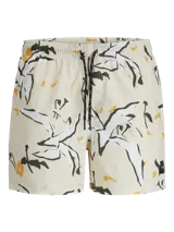 Short de baño color crema con estampado de flores y hojas en blanco, negro y amarillo. Tiene cintura elástica con cordón ajustable, bolsillos laterales y un bolsillo trasero.
