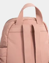 Mochila rosa claro de tela deportiva acolchada con diseño de rombos. Tiene asa de mano, correas regulables, cierre superior, bolsillo frontal con lazo decorativo y bolsillos laterales con lazos.