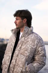 Campera puffer de corderoy con estampado paisley en tonos beige y cuello alto.