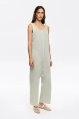 Mono largo color verde claro, de corte holgado, con breteles finos y bolsillos laterales.