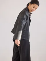 Campera de jean azul con cuello y solapa, corte entallado y largo a la cintura.