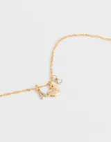 Cadena dorada con dije de strass y corazón de metal.