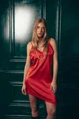 Vestido corto rojo de satén, corte lencero y diseño asimétrico.