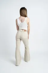 Pantalón acampanado color beige, de tiro alto y corte ajustado en la cadera.