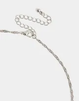 Cadena dorada con dije de corazón delineado con strass.