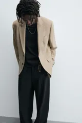 Blazer straight fit color gris confeccionada en tejido con viscosa. Cuello con solapas de muesca y manga larga acabada en puño con botón. Bolsillo de vivo en pecho y bolsillos de plastrón en cadera. Bajo con aberturas en espalda. Cierre frontal de botonadura.