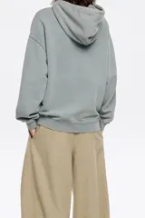 Sudadera rosa de algodón con capucha ajustable con cordones, corte oversize, manga larga y logo bordado.