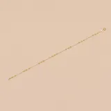 Pulsera dorada de oro amarillo 18k con eslabones finos y pequeñas cuentas esféricas.