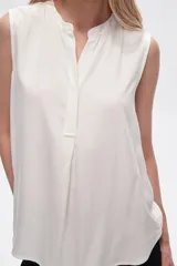 Blusa viscosa color negro, corte evasé, sin mangas, con cuello a la base y botón en la parte superior.