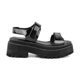 Sandalias negras de charol con plataforma gruesa y suela track.