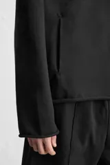 Sudadera con capucha negra, de corte oversize, confeccionada en tejido de algodón con interior en rizo. Cuenta con manga larga, bolsillos frontales tipo canguro, efecto lavado y acabados irregulares con vuelta.