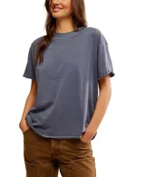Remera gris de corte cuadrado, ligeramente extragrande, con escote redondo, hombros caídos y costuras sin rematar.