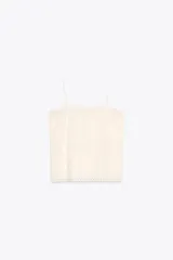 Top blanco de algodón con tirantes finos y bordados combinados a tono.