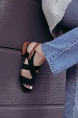 Sandalias de cuero color beige con tiras cruzadas y hebilla lateral. Taco cuadrado color marrón oscuro.