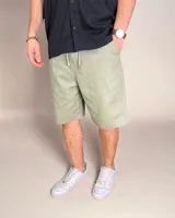 Bermuda de lino color verde oliva, de corte holgado y tiro medio.